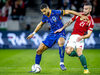 Netherlands forward Cody Gakpo and Hungary defender Endre Botka play during the match between Hungary and the Netherlands at the Puskas Aren...