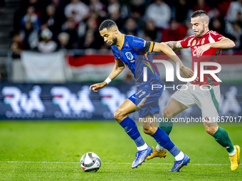 Netherlands forward Cody Gakpo and Hungary defender Endre Botka play during the match between Hungary and the Netherlands at the Puskas Aren...