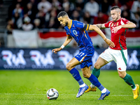 Netherlands forward Cody Gakpo and Hungary defender Endre Botka play during the match between Hungary and the Netherlands at the Puskas Aren...