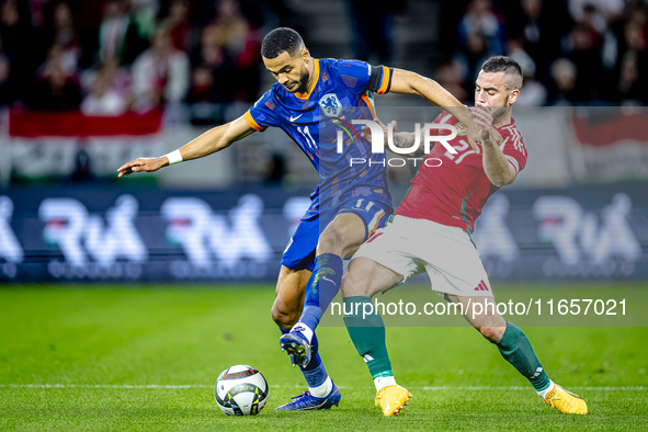 Netherlands forward Cody Gakpo and Hungary defender Endre Botka play during the match between Hungary and the Netherlands at the Puskas Aren...