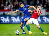 Netherlands forward Cody Gakpo and Hungary defender Endre Botka play during the match between Hungary and the Netherlands at the Puskas Aren...