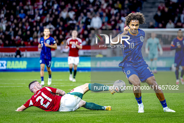 Hungary defender Endre Botka and Netherlands forward Joshua Zirkzee participate in the match between Hungary and the Netherlands at the Pusk...