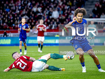 Hungary defender Endre Botka and Netherlands forward Joshua Zirkzee participate in the match between Hungary and the Netherlands at the Pusk...