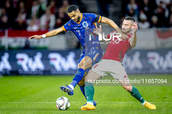 Netherlands forward Cody Gakpo and Hungary defender Endre Botka play during the match between Hungary and the Netherlands at the Puskas Aren...