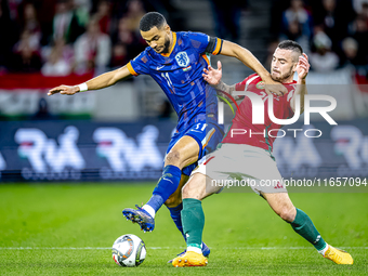 Netherlands forward Cody Gakpo and Hungary defender Endre Botka play during the match between Hungary and the Netherlands at the Puskas Aren...