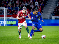 Hungary midfielder Dominik Szoboszlai and Netherlands midfielder Quinten Timber play during the match between Hungary and the Netherlands at...