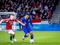 Hungary midfielder Dominik Szoboszlai and Netherlands midfielder Quinten Timber play during the match between Hungary and the Netherlands at...