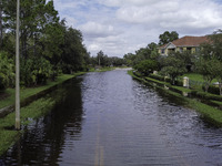 The street floods during Hurricane Milton in the Hunters Creek region, Florida, with water trapped between residents' homes and the lake, on...