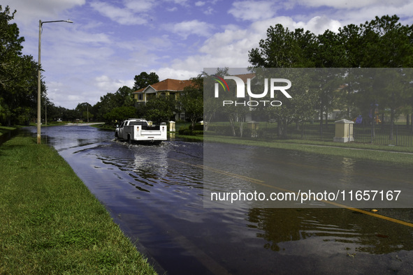 The street floods during Hurricane Milton in the Hunters Creek region, Florida, with water trapped between residents' homes and the lake, on...