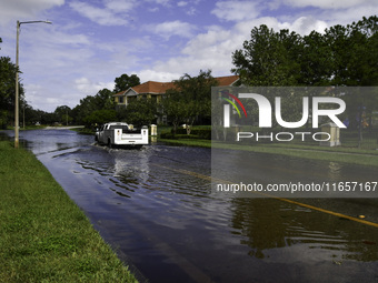 The street floods during Hurricane Milton in the Hunters Creek region, Florida, with water trapped between residents' homes and the lake, on...