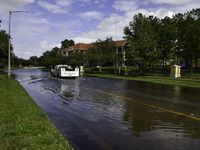 The street floods during Hurricane Milton in the Hunters Creek region, Florida, with water trapped between residents' homes and the lake, on...