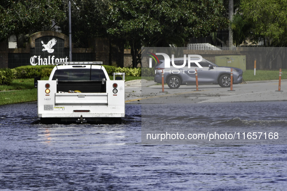 The street floods during Hurricane Milton in the Hunters Creek region, Florida, with water trapped between residents' homes and the lake, on...