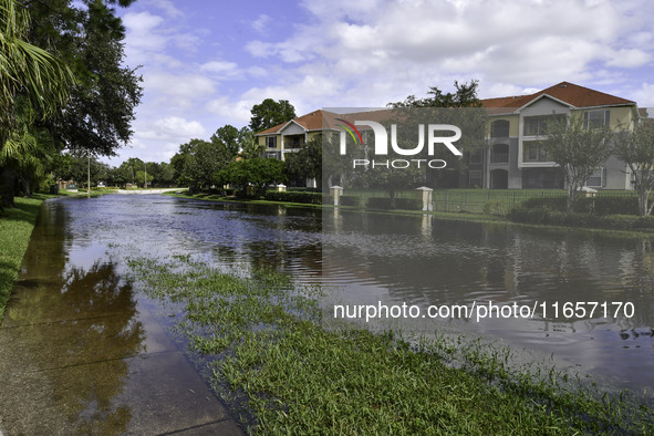 The street floods during Hurricane Milton in the Hunters Creek region, Florida, with water trapped between residents' homes and the lake, on...