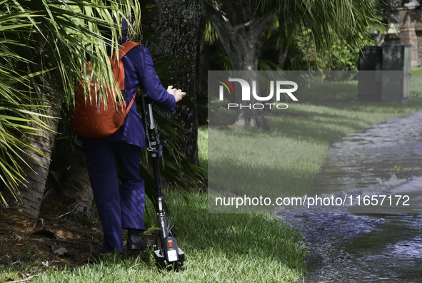 The street floods during Hurricane Milton in the Hunters Creek region, Florida, with water trapped between residents' homes and the lake, on...