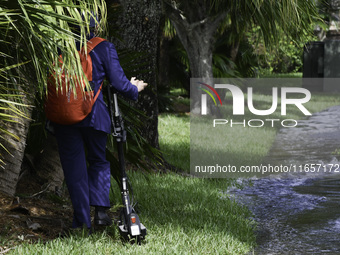 The street floods during Hurricane Milton in the Hunters Creek region, Florida, with water trapped between residents' homes and the lake, on...