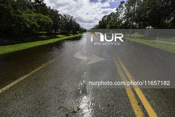 The street floods during Hurricane Milton in the Hunters Creek region, Florida, with water trapped between residents' homes and the lake, on...