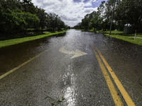 The street floods during Hurricane Milton in the Hunters Creek region, Florida, with water trapped between residents' homes and the lake, on...