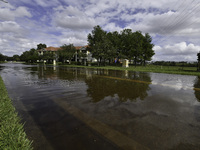 The street floods during Hurricane Milton in the Hunters Creek region, Florida, with water trapped between residents' homes and the lake, on...