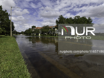 The street floods during Hurricane Milton in the Hunters Creek region, Florida, with water trapped between residents' homes and the lake, on...