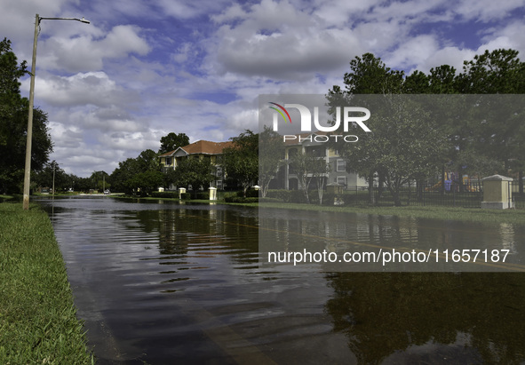 The street floods during Hurricane Milton in the Hunters Creek region, Florida, with water trapped between residents' homes and the lake, on...