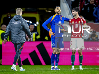 Netherlands forward Cody Gakpo and Hungary midfielder Dominik Szoboszlai play during the match between Hungary and the Netherlands at the Pu...