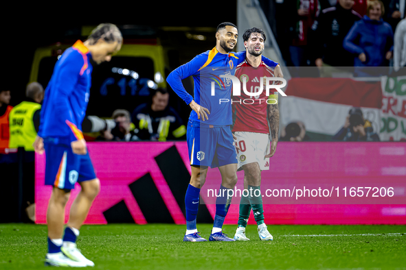 Netherlands forward Cody Gakpo and Hungary midfielder Dominik Szoboszlai play during the match between Hungary and the Netherlands at the Pu...