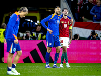 Netherlands forward Cody Gakpo and Hungary midfielder Dominik Szoboszlai play during the match between Hungary and the Netherlands at the Pu...