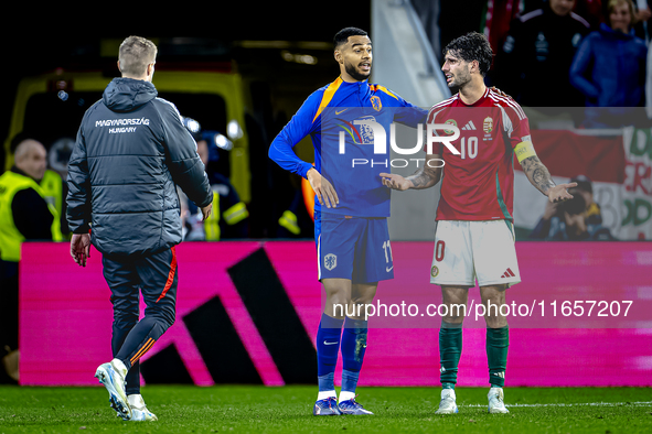 Netherlands forward Cody Gakpo and Hungary midfielder Dominik Szoboszlai play during the match between Hungary and the Netherlands at the Pu...