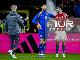 Netherlands forward Cody Gakpo and Hungary midfielder Dominik Szoboszlai play during the match between Hungary and the Netherlands at the Pu...