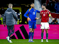 Netherlands forward Cody Gakpo and Hungary midfielder Dominik Szoboszlai play during the match between Hungary and the Netherlands at the Pu...