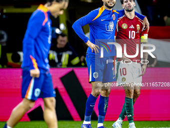 Netherlands forward Cody Gakpo and Hungary midfielder Dominik Szoboszlai play during the match between Hungary and the Netherlands at the Pu...