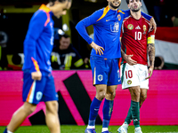 Netherlands forward Cody Gakpo and Hungary midfielder Dominik Szoboszlai play during the match between Hungary and the Netherlands at the Pu...