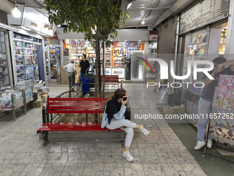 Iranian youths are at a shopping center in Shiraz, Iran, on October 8, 2024.  (