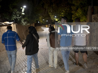 A group of Iranian youths walks along a path in the city of Shiraz in Fars province, about 932 km (579 miles) south of Tehran, Iran, at nigh...