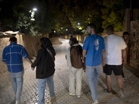 A group of Iranian youths walks along a path in the city of Shiraz in Fars province, about 932 km (579 miles) south of Tehran, Iran, at nigh...