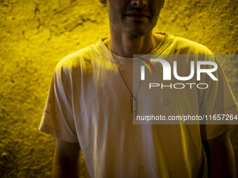 A young Iranian man wears a bullet while posing for a photograph outside a garden in Shiraz, Iran, on October 8, 2024. Western countries exp...