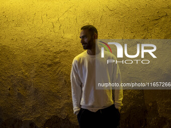 A young Iranian man poses for a photograph while standing outside a garden in Shiraz, Iran, on October 8, 2024, at night. While Western coun...