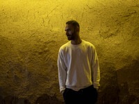 A young Iranian man poses for a photograph while standing outside a garden in Shiraz, Iran, on October 8, 2024, at night. While Western coun...