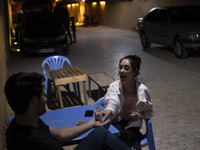 Iranian youths sit at an outdoor cafe in a garden in Shiraz, Iran, on October 7, 2024, while Western countries express concern about a poten...