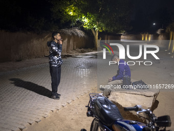 A young Iranian man puffs on a cigarette while standing on a path out of a garden in Shiraz, Iran, on October 8, 2024. Western countries exp...