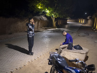 A young Iranian man puffs on a cigarette while standing on a path out of a garden in Shiraz, Iran, on October 8, 2024. Western countries exp...