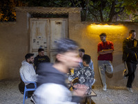 A group of young Iranian men gathers at an outdoor cafe in a garden in Shiraz, Iran, on October 8, 2024, about 932 km (579 miles) south of T...