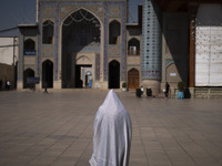 A veiled Iranian woman walks in a holy shrine in Shiraz, Iran, on October 8, 2024. While Western countries express concern about a potential...