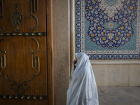 A veiled Iranian woman walks in a holy shrine in Shiraz, Iran, on October 8, 2024. While Western countries express concern about a potential...