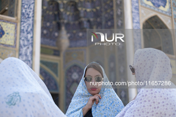 Veiled Iranian women stand together in a holy shrine in Shiraz, Iran, on October 8, 2024. While Western countries express concern about a po...