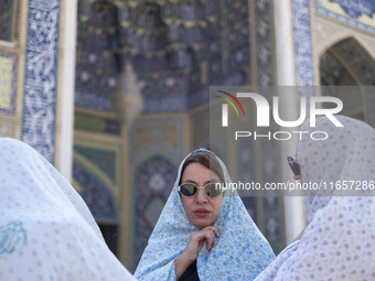 Veiled Iranian women stand together in a holy shrine in Shiraz, Iran, on October 8, 2024. While Western countries express concern about a po...