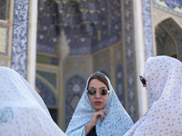 Veiled Iranian women stand together in a holy shrine in Shiraz, Iran, on October 8, 2024. While Western countries express concern about a po...