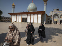 Veiled Iranian women walk along an area in a holy shrine in Shiraz, Iran, on October 8, 2024. Western countries express concern about a pote...