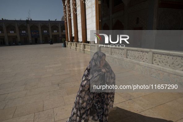 A veiled Iranian woman walks in a holy shrine in Shiraz, Iran, on October 8, 2024. While Western countries express concern about a potential...