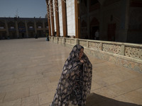 A veiled Iranian woman walks in a holy shrine in Shiraz, Iran, on October 8, 2024. While Western countries express concern about a potential...